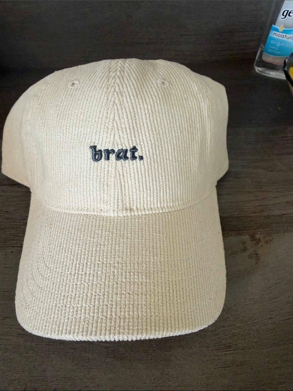 Karma Cream Corduroy Cap with Navy "brat." Embroidery